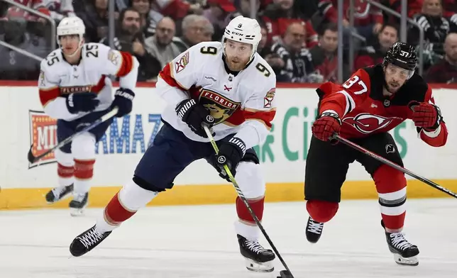 Florida Panthers center Sam Bennett (9), center, skates with the puck during the first period of an NHL hockey game against the New Jersey Devils, Tuesday, Jan. 14, 2025, in Newark, N.J. (AP Photo/Julia Demaree Nikhinson)