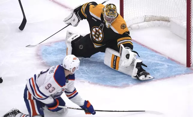 Boston Bruins goaltender Jeremy Swayman (1) gloves the save on a shot by Edmonton Oilers center Ryan Nugent-Hopkins (93) during the second period of an NHL hockey game, Tuesday, Jan. 7, 2025, in Boston. (AP Photo/Charles Krupa)