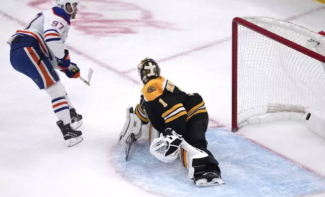 Edmonton Oilers center Connor McDavid (97) scores on Boston Bruins goaltender Jeremy Swayman (1) during the second period of an NHL hockey game, Tuesday, Jan. 7, 2025, in Boston. (AP Photo/Charles Krupa)