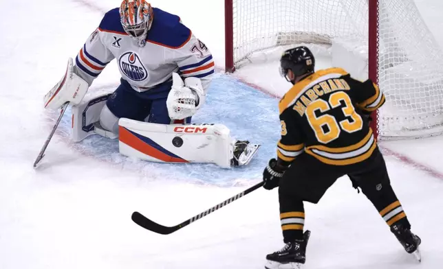 Edmonton Oilers goaltender Stuart Skinner (74) makes a pad save on a shot by Boston Bruins left wing Brad Marchand (63) during the third period of an NHL hockey game, Tuesday, Jan. 7, 2025, in Boston. (AP Photo/Charles Krupa)