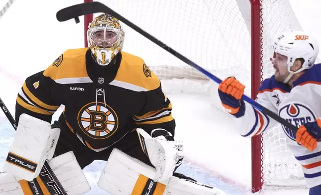 Boston Bruins goaltender Jeremy Swayman (1) keeps his eyes on the puck against Edmonton Oilers left wing Viktor Arvidsson, right, during the second period of an NHL hockey game, Tuesday, Jan. 7, 2025, in Boston. (AP Photo/Charles Krupa)