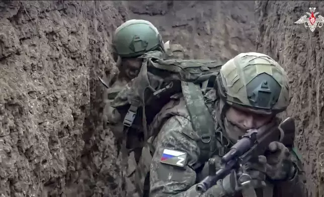 In this photo taken from video distributed by Russian Defense Ministry Press Service on Saturday, Jan. 4, 2025, Russian servicemen attend a combat training for assault units in an undisclosed location. (Russian Defense Ministry Press Service via AP)