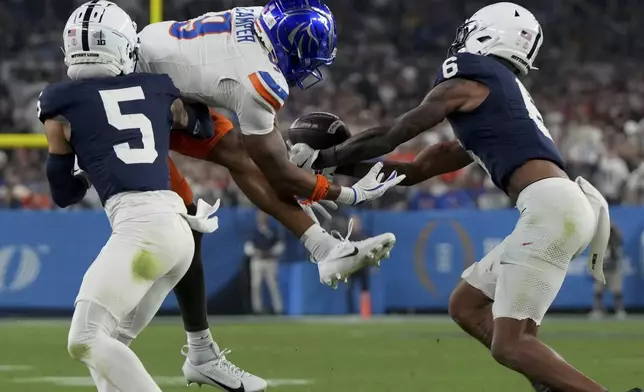 Penn State safety Zakee Wheatley (6) intercepts a pass intended for Boise State wide receiver Cameron Camper (9) during the second half of the Fiesta Bowl College Football Playoff game, Tuesday, Dec. 31, 2024, in Glendale, Ariz. (AP Photo/Rick Scuteri)