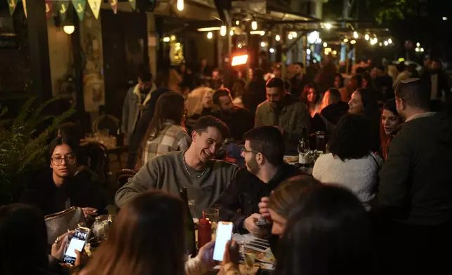 People celebrate the New Year in Tel Aviv, Israel, Wednesday, Jan. 1, 2025. (AP Photo/Matias Delacroix)