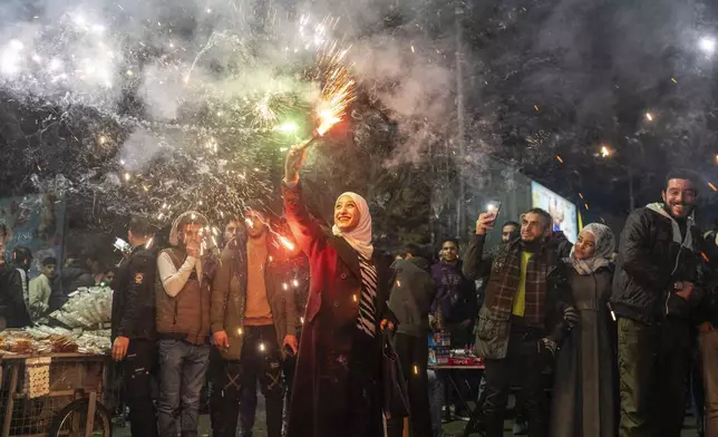 Syrians celebrate the new year after the ousting of Assad regime, in Damascus, Syria, Tuesday, Dec. 31, 2024. (AP Photo/Mosa'ab Elshamy)