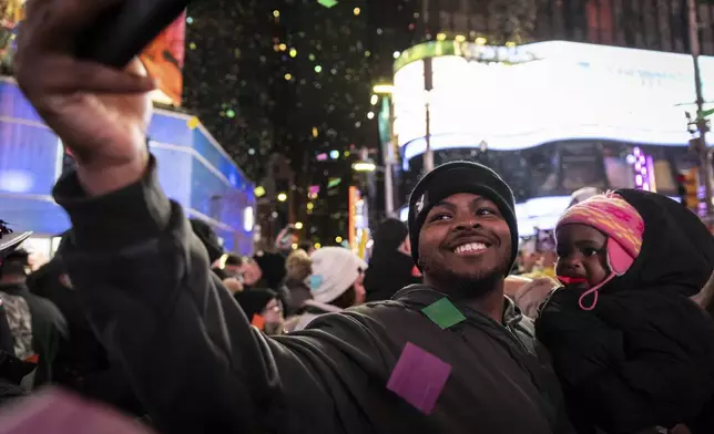 Revelers celebrate after the ball drops in New York's Times Square, Wednesday, Jan. 1, 2025, in New York. (AP Photo/Stefan Jeremiah)