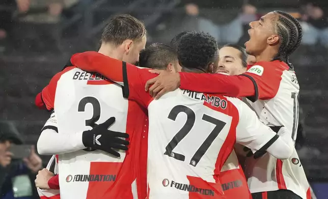 Feyenoord's Santiago Gimenez celebrates with teammates after scoring his side's second goal during the Champions League opening phase soccer match between Feyenoord and Bayern Munich, at De Kuip Stadium, in Rotterdam, Netherlands, Wednesday, Jan. 22, 2025. (AP Photo/Peter Dejong)