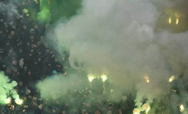 Feyenoord fans light firework during the Champions League opening phase soccer match between Feyenoord and Bayern Munich, at De Kuip Stadium, in Rotterdam, Netherlands, Wednesday, Jan. 22, 2025. (AP Photo/Peter Dejong)