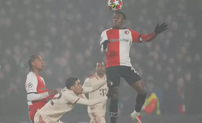 Feyenoord's Antoni Milambo heads the ball during the Champions League opening phase soccer match between Feyenoord and Bayern Munich, at De Kuip Stadium, in Rotterdam, Netherlands, Wednesday, Jan. 22, 2025. (AP Photo/Peter Dejong)