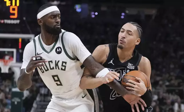 Brooklyn Nets' Jalen Wilson tries to get past Milwaukee Bucks' Bobby Portis during the first half of an NBA basketball game Thursday, Jan. 2, 2025, in Milwaukee. (AP Photo/Morry Gash)