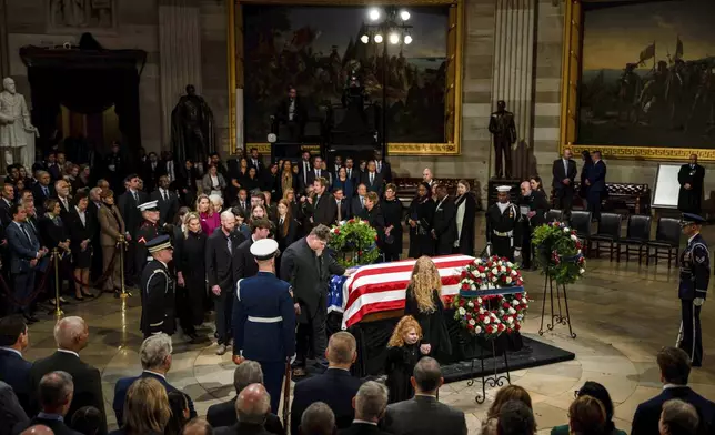 The Carter family pay their respects during a ceremony as the flag-draped casket of former President Jimmy Carter lies in state, at the Capitol, Tuesday, Jan. 7, 2025, in Washington. Carter died Dec. 29 at the age of 100. (Kent Nishimura/The New York Times via AP, Pool)