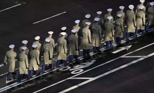 Members of the U.S. Navy line up to march with the casket of former President Jimmy Carter before it arrives at the U.S. Navy Memorial to travel to the Capitol in Washington to lie in state, Tuesday, Jan. 7, 2025. Carter died Dec. 29 at the age of 100. (AP Photo/Mark Schiefelbein, Pool)