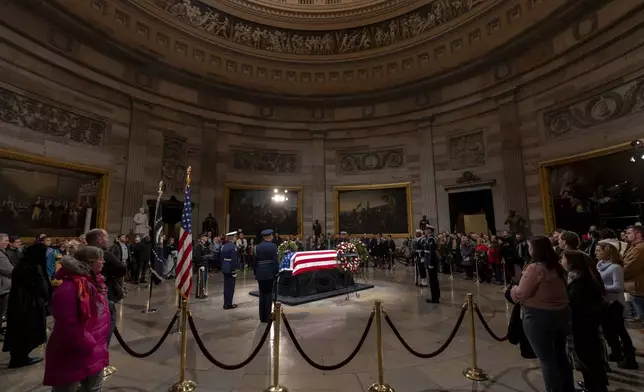 Members of the public view the flag-draped casket of former President Jimmy Carter as he lies in state in the Rotunda, at the Capitol in Washington, Tuesday, Jan. 7, 2025. (AP Photo/Ben Curtis)