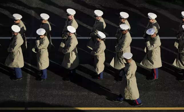 Members of the U.S. Navy line up to march with the casket of former President Jimmy Carter before it arrives at the U.S. Navy Memorial to travel to the Capitol in Washington to lie in state, Tuesday, Jan. 7, 2025. Carter died Dec. 29 at the age of 100. (AP Photo/Mark Schiefelbein, Pool)