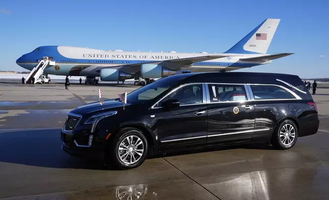 The hearse carrying the flag-draped casket of former President Jimmy Carter prepares to depart Joint Base Andrews, Md., Tuesday, Jan. 7, 2025. Carter died Dec. 29, at the age of 100. (AP Photo/Susan Walsh, Pool)