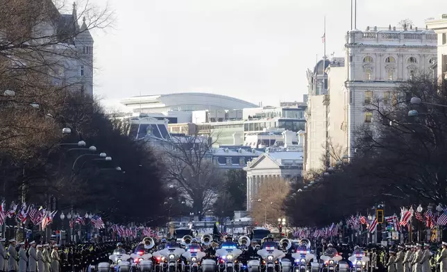 The flag-draped casket of former President Jimmy Carter moves toward the U.S. Capitol on a horse-drawn caisson, Tuesday, Jan. 7, 2025 in Washington. Carter died Dec. 29, 2024, at the age of 100. (Brendan McDermid/Pool via AP)