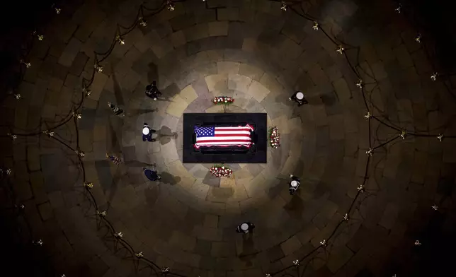 The flag-draped casket of former President Jimmy Carter lies in state at the rotunda of the U.S. Capitol Tuesday, Jan. 7, 2025, in Washington. (Andrew Harnik/Pool via AP)