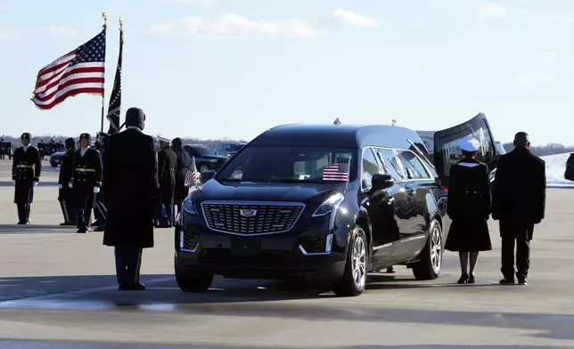 The flag-draped casket of former President Jimmy Carter is placed into the hearse at Joint Base Andrews, Md., Tuesday, Jan. 7, 2025. Carter died Dec. 29, at the age of 100. (AP Photo/Susan Walsh, Pool)