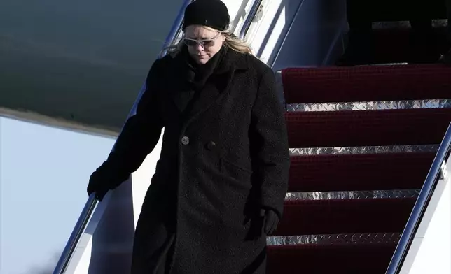 Amy Carter arrives on Special Air Mission 39 before the flag-draped casket of former President Jimmy Carter is taken from the plane at Joint Base Andrews, Md., Tuesday, Jan. 7, 2025. Carter died Dec. 29, at the age of 100. (AP Photo/Susan Walsh, Pool)