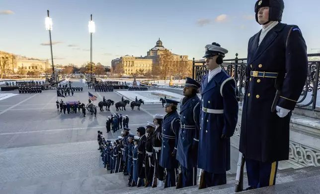 A joint services body bearer team prepares to move the casket of former President Jimmy Carter after it arrived on a horse-drawn caisson at the East Front of U.S. Capitol in Washington, Tuesday, Jan. 7, 2025. (Shawn Thew/Pool via AP)