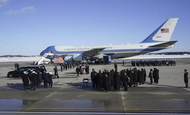 A joint services military body bearer team carries the flag-draped casket of former President Jimmy Carter on arrival at Joint Base Andrews, Md., Tuesday, Jan. 7, 2025, and will travel on to the Capitol where he will lie in State. Carter died Dec. 29 at the age of 100. (AP Photo/Steve Helber)