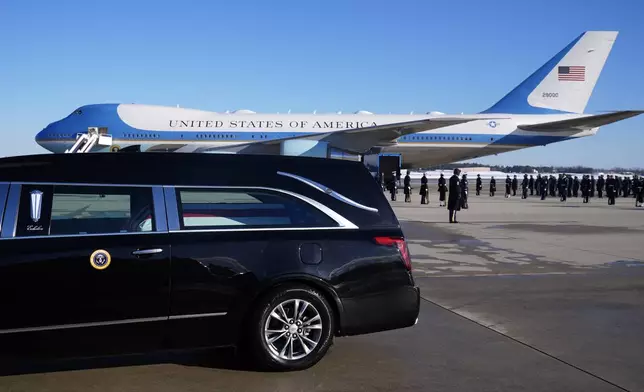 The hearse carrying the flag-draped casket of former President Jimmy Carter prepares to depart Joint Base Andrews, Md., Tuesday, Jan. 7, 2025. Carter died Dec. 29, at the age of 100. (AP Photo/Susan Walsh, Pool)