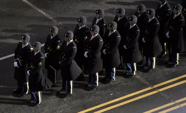 Members of the joint services military honor guard line up before the casket of former President Jimmy Carter arrives at the U.S. Navy Memorial to travel to the Capitol in Washington to lie in state, Tuesday, Jan. 7, 2025. Carter died Dec. 29 at the age of 100. (AP Photo/Mark Schiefelbein, Pool)