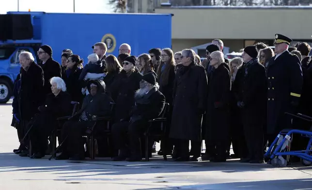 Members of the Carter family watch as joint forces body bearer team moves the flag-draped casket of former President Jimmy Carter upon arrival at Joint Base Andrews, Md., Tuesday, Jan. 7, 2025. Carter died Dec. 29, at the age of 100. (AP Photo/Susan Walsh, Pool)