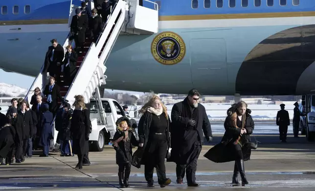 Members of the Carter family arrive on Special Air Mission 39 before the flag-draped casket of former President Jimmy Carter is taken from the plane at Joint Base Andrews, Md., Tuesday, Jan. 7, 2025. Carter died Dec. 29, at the age of 100. (AP Photo/Susan Walsh, Pool)