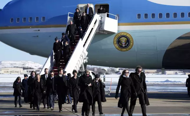 Members of the Carter family arrive on Special Air Mission 39 before the flag-draped casket of former President Jimmy Carter is taken from the plane at Joint Base Andrews, Md., Tuesday, Jan. 7, 2025. Carter died Dec. 29, at the age of 100. (AP Photo/Susan Walsh, Pool)