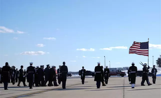 A joint forces body bearer team moves the flag-draped casket of former President Jimmy Carter upon arrival at Joint Base Andrews, Md., Tuesday, Jan. 7, 2025. Carter died Dec. 29, at the age of 100. (AP Photo/Susan Walsh, Pool)