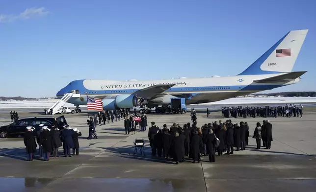 A joint services military body bearer team carries the flag-draped casket of former President Jimmy Carter on arrival at Joint Base Andrews, Md., Tuesday, Jan. 7, 2025, and will travel on to the Capitol where he will lie in State. Carter died Dec. 29 at the age of 100. (AP Photo/Steve Helber)