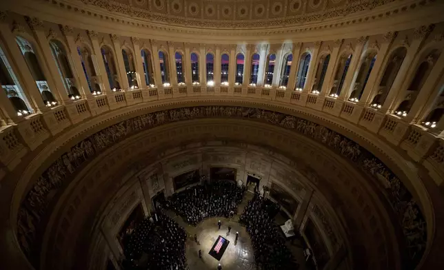 The flag-draped casket of former President Jimmy Carter lies in state at the rotunda of the U.S. Capitol Tuesday, Jan. 7, 2025, in Washington. (Andrew Harnik/Pool via AP)