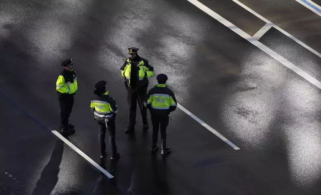 Police look on before the casket of former President Jimmy Carter arrives at the U.S. Navy Memorial before traveling on to the Capitol in Washington, Tuesday, Jan. 7, 2025, where Carter will lie in state. Carter died Dec. 29 at the age of 100. (AP Photo/Mark Schiefelbein, Pool)