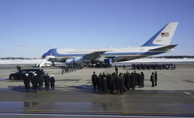 A joint services military body bearer team prepares to carry the flag-draped casket of former President Jimmy Carter on arrival at Joint Base Andrews, Md., Tuesday, Jan. 7, 2025, and will travel to the Capitol where he will lie in State. Carter died Dec. 29 at the age of 100. (AP Photo/Steve Helber)