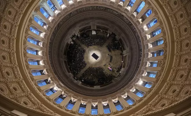 The flag-draped casket of former President Jimmy Carter is carried by a joint services body bearer team into U.S. Capitol Rotunda where he will lie in state, Tuesday, Jan. 7, 2025, in Washington. (Andrew Harnik/Pool via AP)