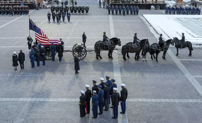 A joint services body bearer team moves the casket of former President Jimmy Carter after it arrived on a horse-drawn caisson at the East Front of U.S. Capitol in Washington, Tuesday, Jan. 7, 2025. (Shawn Thew/Pool via AP)