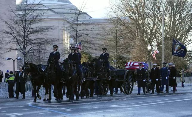 The casket containing the remains of former President Jimmy Carter moves toward the U.S. Capitol on a horse-drawn caisson in Washington, Tuesday, Jan. 7, 2025. Carter died Dec. 29, 2024, at the age of 100. (AP Photo/Susan Walsh, Pool)