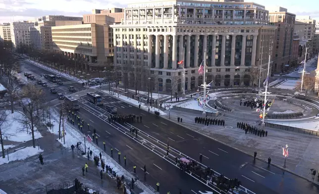 The flag-draped casket of former President Jimmy Carter travels in a horse-drawn caisson from the U.S. Navy Memorial to the Capitol to lie in state in Washington, Tuesday, Jan. 7, 2025. Carter died Dec. 29 at the age of 100. (AP Photo/Mark Schiefelbein, Pool)