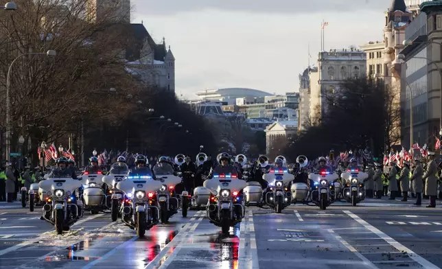 The flag-draped casket of former President Jimmy Carter moves toward the U.S. Capitol on a horse-drawn caisson, Tuesday, Jan. 7, 2025 in Washington. Carter died Dec. 29, 2024, at the age of 100. (Brendan McDermid/Pool via AP)