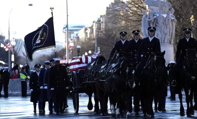 The casket containing the remains of former President Jimmy Carter moves toward the U.S. Capitol on a horse-drawn caisson in Washington, Tuesday, Jan. 7, 2025. Carter died Dec. 29, 2024, at the age of 100. (AP Photo/Susan Walsh, Pool)