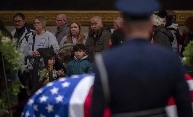 Members of the public view the flag-draped casket of former President Jimmy Carter as he lies in state in the Rotunda, at the Capitol in Washington, Tuesday, Jan. 7, 2025. (AP Photo/Ben Curtis)