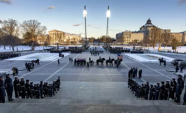 A horse-drawn caisson with the flag-draped casket of former President Jimmy Carter arrives at the U.S. Capitol, Tuesday, Jan. 7, 2025 in Washington. Carter died Dec. 29, 2024, at the age of 100. (Shawn Thew/Pool via AP)