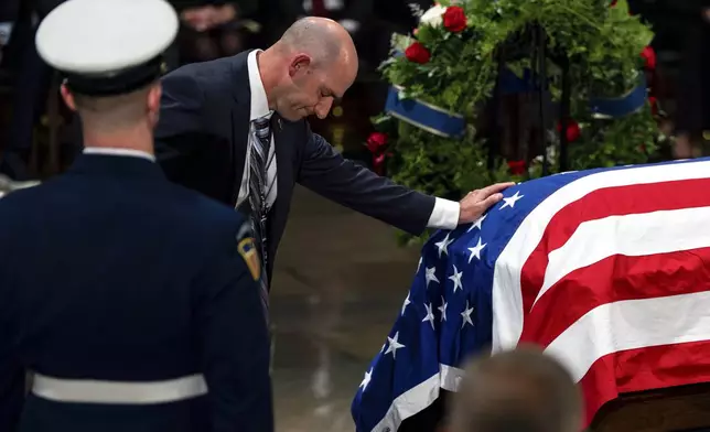 The Carter family pay their respects during a ceremony as the flag-draped casket of former President Jimmy Carter lies in state, at the Capitol, Tuesday, Jan. 7, 2025, in Washington. Carter died Dec. 29 at the age of 100. (Kent Nishimura/The New York Times via AP, Pool)