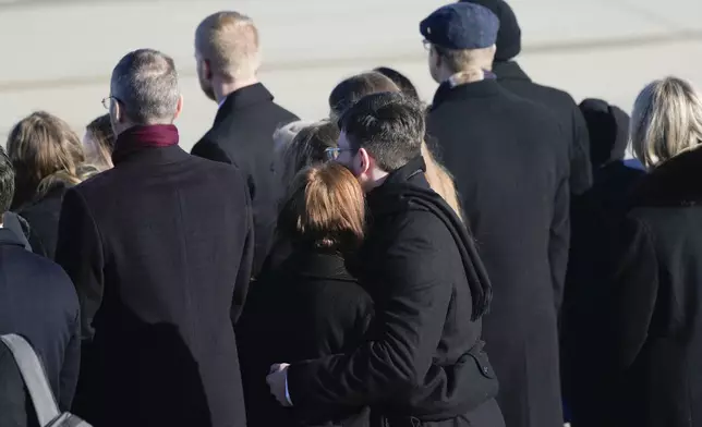 The Carter family looks on as the flag-draped casket of former President Jimmy Carter arrives at Joint Base Andrews, Md., Tuesday, Jan. 7, 2025, and will then travel to the Capitol where he will lie in State. Carter died Dec. 29 at the age of 100. (AP Photo/Steve Helber)