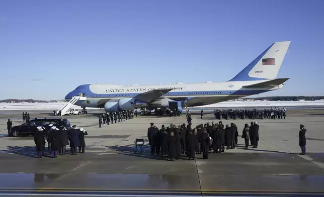 A joint services military body bearer team prepares to carry the flag-draped casket of former President Jimmy Carter on arrival at Joint Base Andrews, Md., Tuesday, Jan. 7, 2025, and will travel to the Capitol where he will lie in State. Carter died Dec. 29 at the age of 100. (AP Photo/Steve Helber)