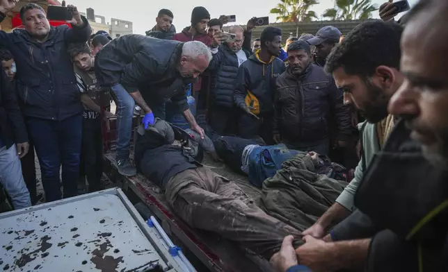 REMOVES NUMBER OF KILLED - The bodies of men killed in an Israeli army strike targeting a car are brought to Al-Aqsa Martyrs hospital in Deir al-Balah, central Gaza Strip, Friday, Jan. 3, 2025. (AP Photo/Abdel Kareem Hana)