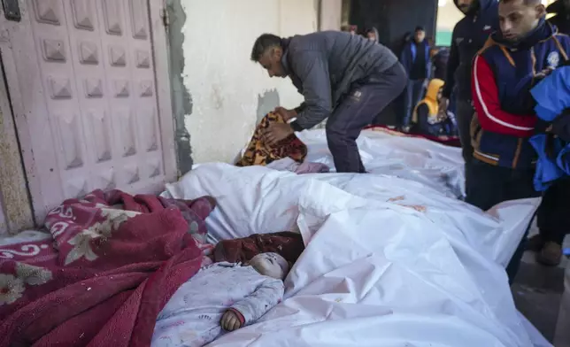 The body of 6-month-old Mohammad Abu Libda lies among other victims of overnight Israeli army strikes at multiple locations in the central Gaza Strip at Al-Aqsa Martyrs Hospital in Deir al-Balah, Friday, Jan. 3, 2025. According to Al-Aqsa Martyrs Hospital, 30 people, including 10 women and 7 children, were killed in several attacks overnight in central Gaza. (AP Photo/Abdel Kareem Hana)