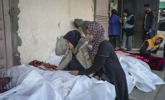 Relatives mourn over the bodies of victims of overnight Israeli army strikes at multiple locations in central Gaza Strip, at Al-Aqsa Martyrs Hospital in Deir al-Balah, Friday, Jan. 3, 2025. According to Al-Aqsa Martyrs Hospital, 30 people, including 10 women and 7 children, were killed in several attacks overnight in central Gaza. (AP Photo/Abdel Kareem Hana)