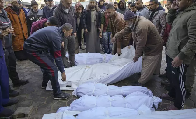 The bodies of victims from overnight Israeli army strikes at multiple locations in the central Gaza Strip are laid together for funeral prayers, at Al-Aqsa Martyrs Hospital in Deir al-Balah, Friday, Jan. 3, 2025. According to Al-Aqsa Martyrs Hospital, 30 people, including 10 women and 7 children, were killed in several attacks overnight in central Gaza. (AP Photo/Abdel Kareem Hana)